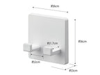ABS樹脂製の【MIST/ミスト】フィルムフック シェーバーホルダーが光沢のある平らな壁面に取り付けられている様子